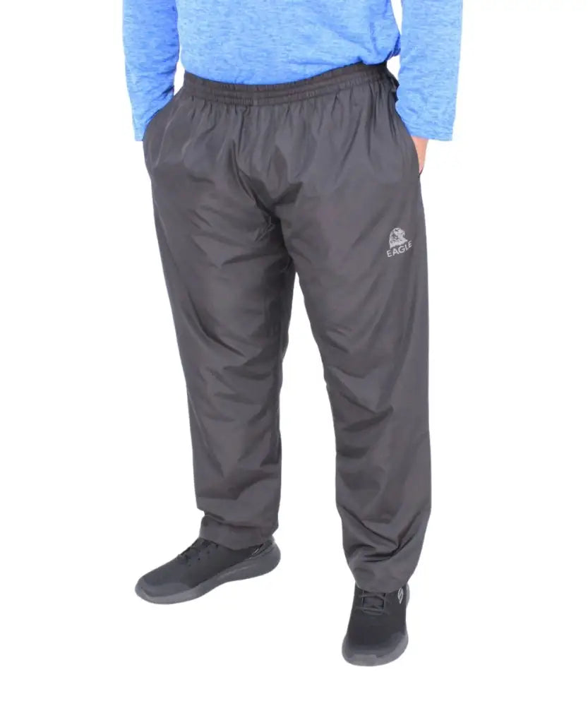 Dark gray mens tracksuit pants with elastic waistband and logo on upper thigh
